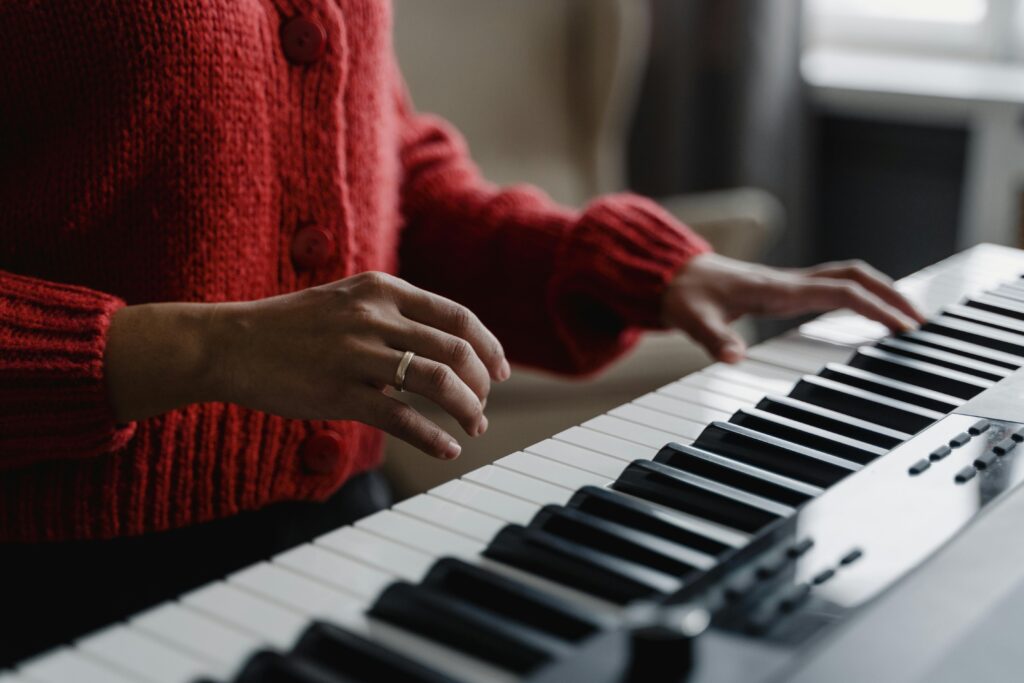 hands playing an electric piano