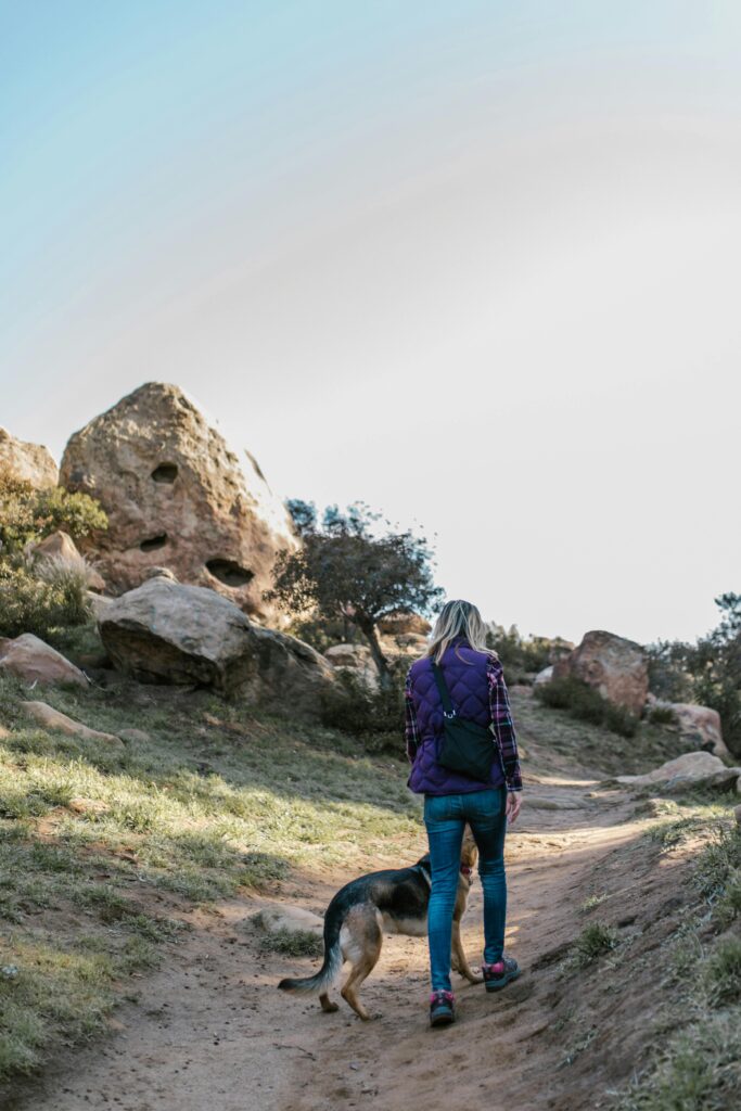 Why Taking a Break Might Be the Best Thing for Your Music 2 Woman hiking on a trail with her dog.
